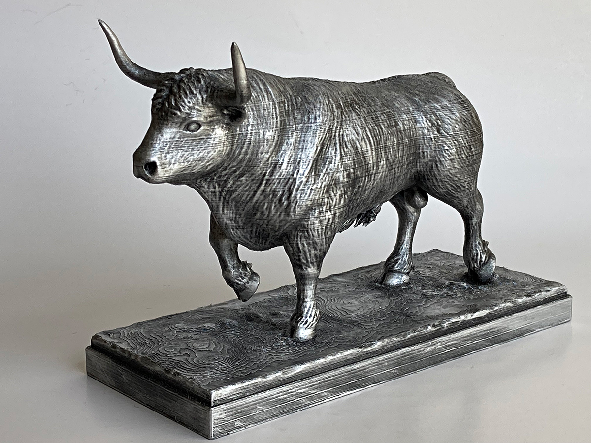 3D printed bull sculpture with a silver finish and oxidation effect, displayed on a detailed rectangular base